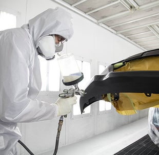 Collision Center Technician Painting a Vehicle | Sloane Toyota of Philadelphia in Philadelphia PA