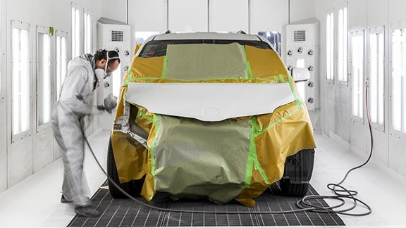 Collision Center Technician Painting a Vehicle | Sloane Toyota of Philadelphia in Philadelphia PA